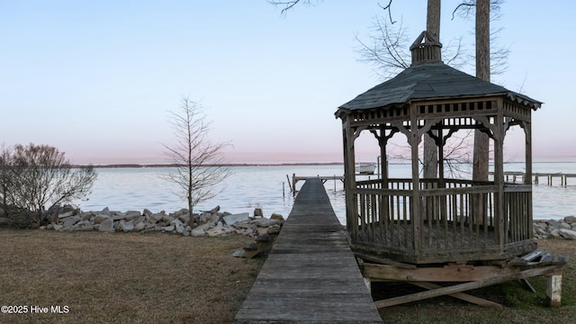 view of dock featuring a gazebo and a water view