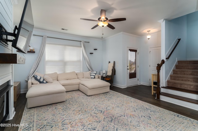 living room with baseboards, visible vents, stairway, ornamental molding, and wood finished floors