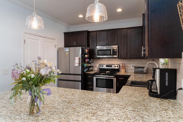 kitchen featuring light stone counters, backsplash, appliances with stainless steel finishes, a sink, and dark brown cabinets