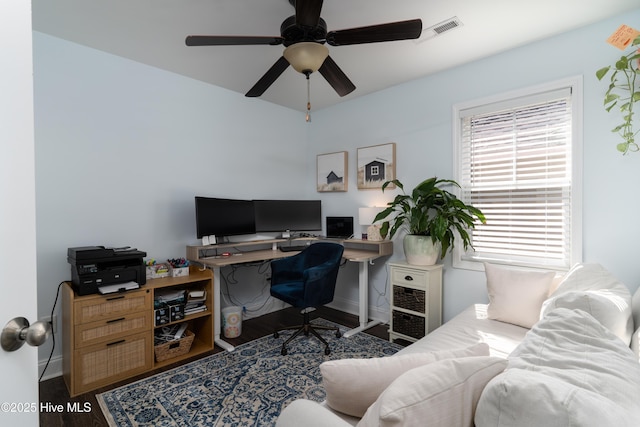 office featuring ceiling fan, wood finished floors, visible vents, and baseboards