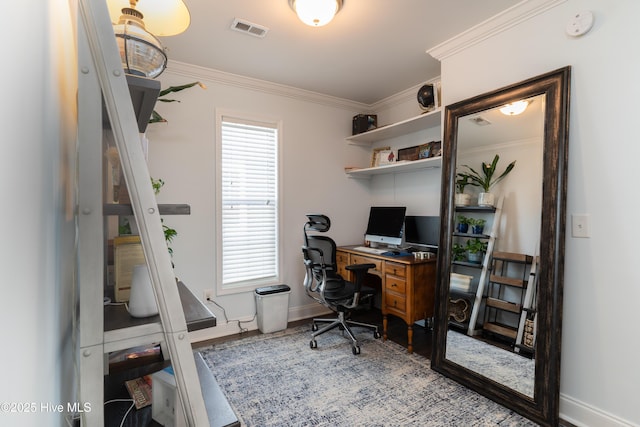 home office with baseboards, visible vents, wood finished floors, and ornamental molding