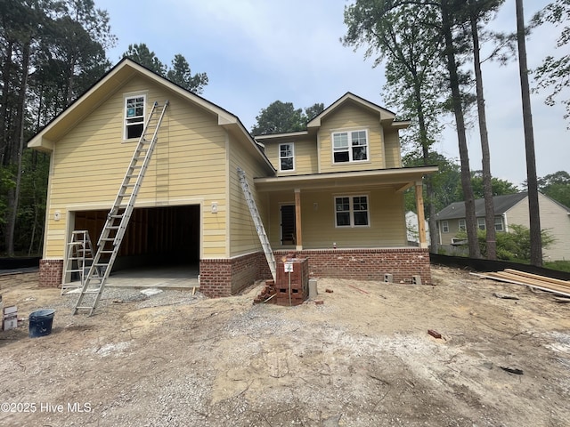 859 Blue Bird Dr, Vass, NC 28394 - view of front of house featuring covered porch, an attached garage, and dirt driveway
