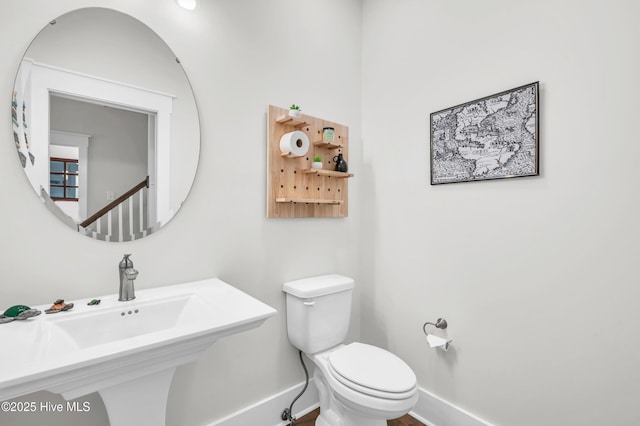 1066 Bradshaw Ter, Wilmington, NC 28412 - bathroom with baseboards, toilet, and a sink