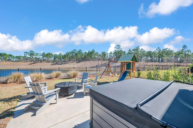 1066 Bradshaw Ter, Wilmington, NC 28412 - view of patio / terrace with a fenced backyard, a playground, a fire pit, and a hot tub