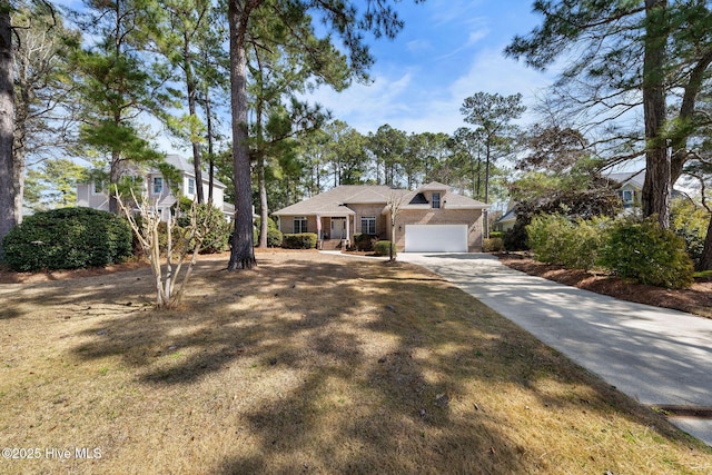 view of front of property with driveway, brick siding, and an attached garage