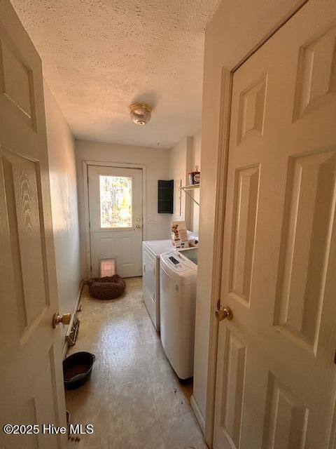 laundry area with laundry area, a textured ceiling, and separate washer and dryer