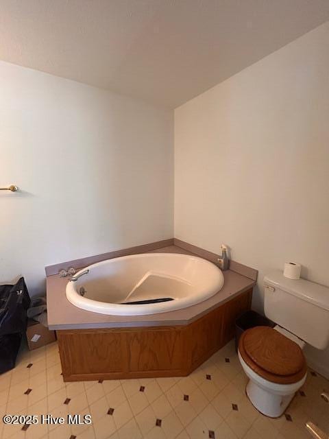 full bathroom with a bath and toilet