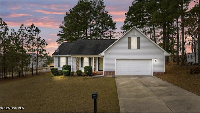 traditional-style house featuring a garage, a front lawn, concrete driveway, and roof with shingles