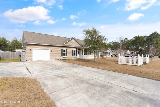 ranch-style house with a garage, driveway, a front lawn, and fence