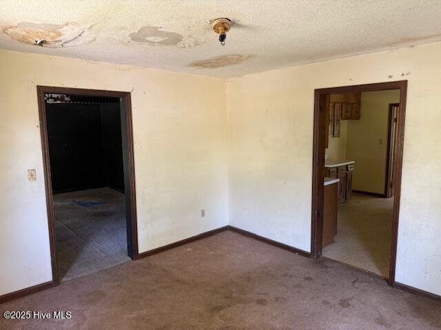 350 Randolphville Rd NE, Bolivia, NC 28422 - carpeted empty room featuring baseboards and a textured ceiling