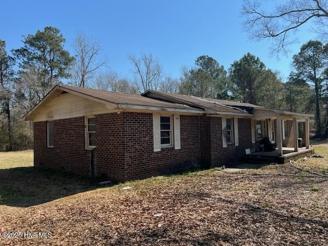 view of side of home with brick siding