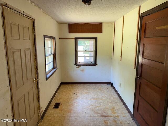 350 Randolphville Rd NE, Bolivia, NC 28422 - spare room featuring baseboards, a textured ceiling, and visible vents