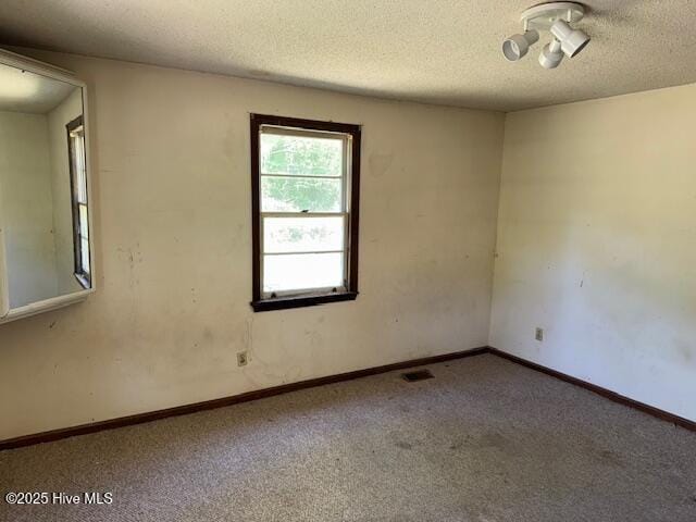 350 Randolphville Rd NE, Bolivia, NC 28422 - unfurnished room with carpet floors, a textured ceiling, visible vents, and baseboards