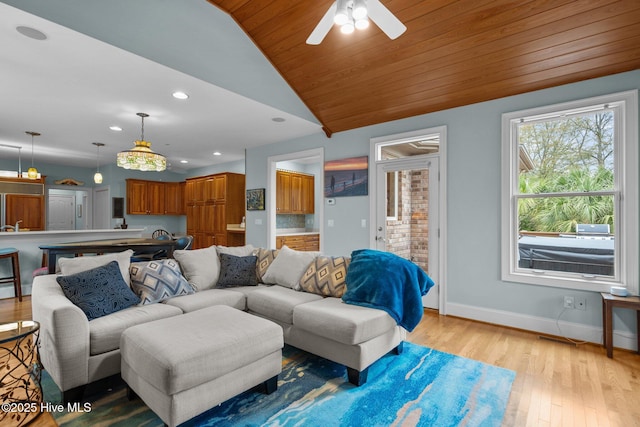 living area featuring a ceiling fan, vaulted ceiling, baseboards, light wood finished floors, and recessed lighting