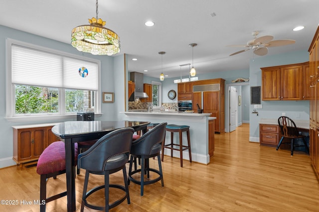 dining area featuring recessed lighting, ceiling fan, baseboards, and light wood finished floors