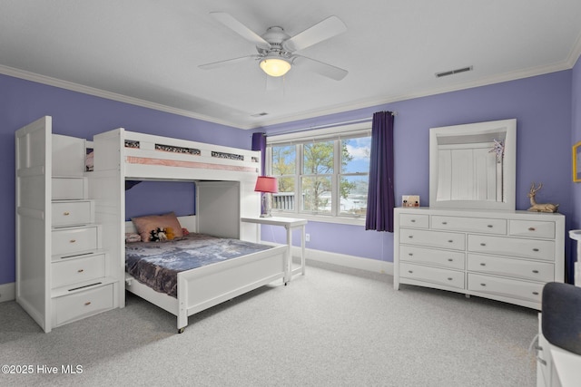 bedroom with light colored carpet, ornamental molding, and baseboards