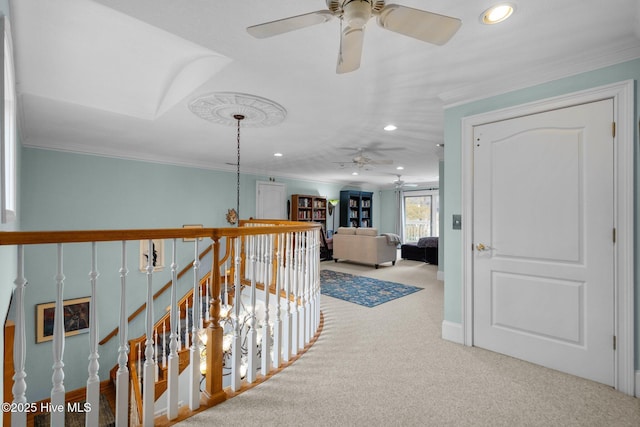 hall featuring carpet flooring, recessed lighting, crown molding, and an upstairs landing
