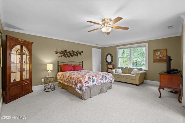 bedroom featuring ceiling fan, visible vents, crown molding, carpet floors, and baseboards