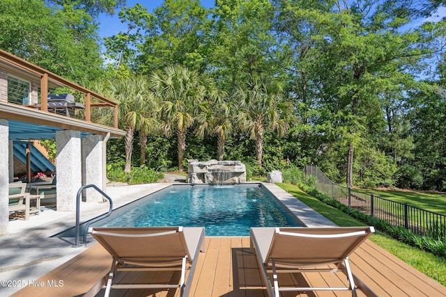 view of swimming pool featuring fence, a fenced in pool, a patio, and a deck