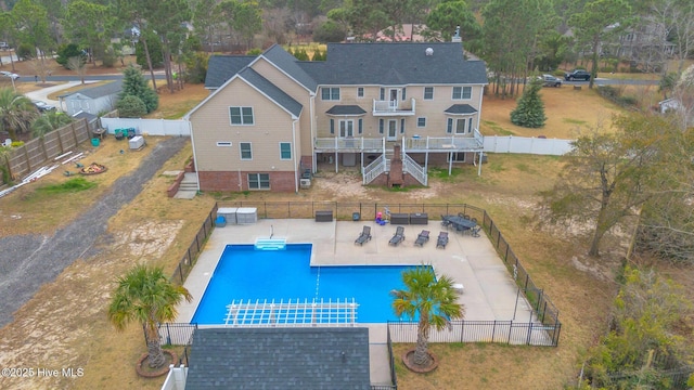 exterior space featuring a lawn, a patio, a fenced backyard, a fenced in pool, and stairs