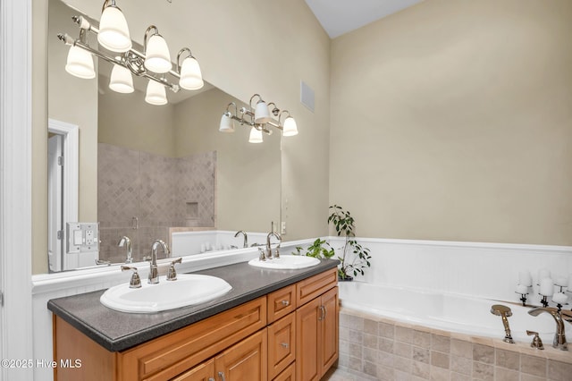 full bath with a notable chandelier, visible vents, a garden tub, and a sink