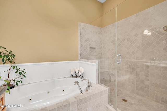 full bath featuring a jetted tub and a stall shower