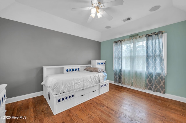 bedroom with wood finished floors, baseboards, ceiling fan, and vaulted ceiling
