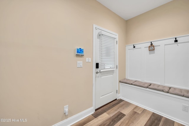 mudroom with wood finished floors and baseboards