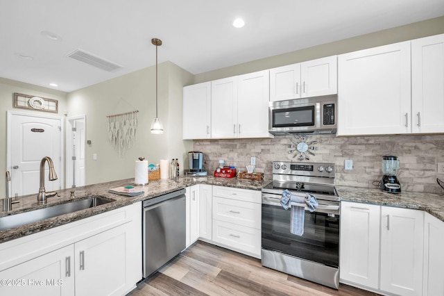 kitchen featuring a sink, visible vents, appliances with stainless steel finishes, and white cabinets