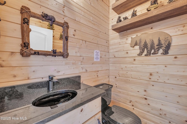 bathroom with wooden walls and vanity