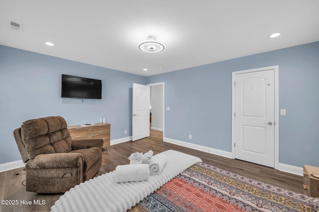 living area featuring wood finished floors, baseboards, and recessed lighting