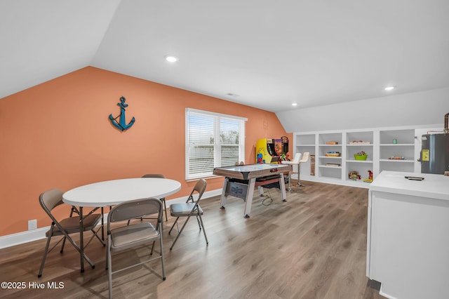 game room with vaulted ceiling, water heater, light wood-style flooring, recessed lighting, and baseboards