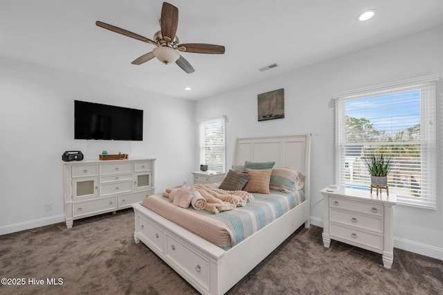 bedroom featuring multiple windows, visible vents, baseboards, and carpet floors