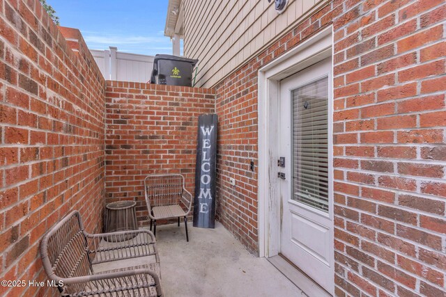 view of exterior entry with brick siding