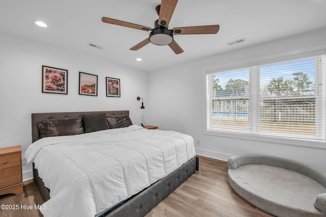 bedroom featuring wood finished floors, baseboards, recessed lighting, and ceiling fan