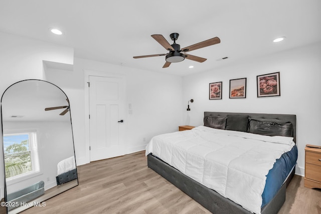 bedroom with wood finished floors, recessed lighting, baseboards, and a ceiling fan