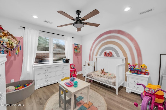 bedroom featuring recessed lighting, wood finished floors, and visible vents