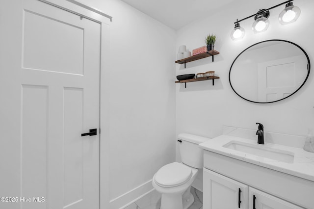half bath with vanity, toilet, marble look tiles, and baseboards