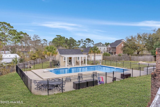 view of swimming pool with an outbuilding, a yard, fence, and an exterior structure