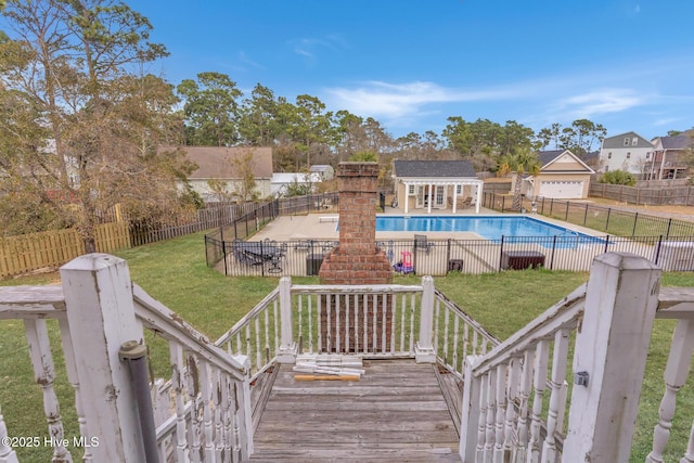 view of pool featuring an outdoor structure, a patio, and a storage structure