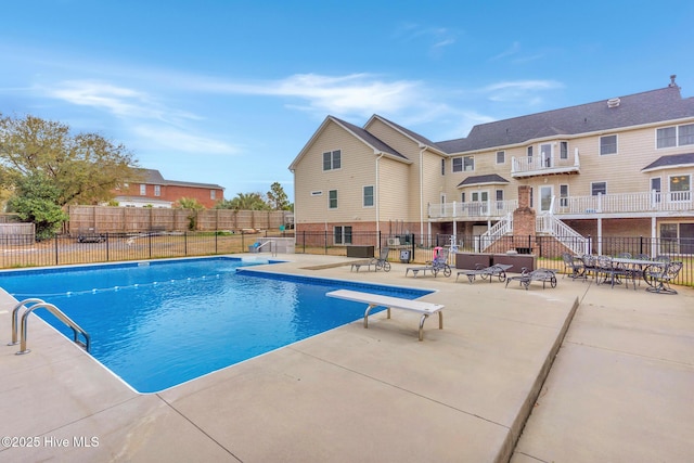 view of swimming pool with a fenced in pool, a patio area, and fence