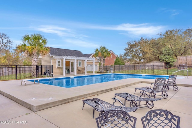 view of pool with an outbuilding, a storage structure, a fenced backyard, a fenced in pool, and a patio area