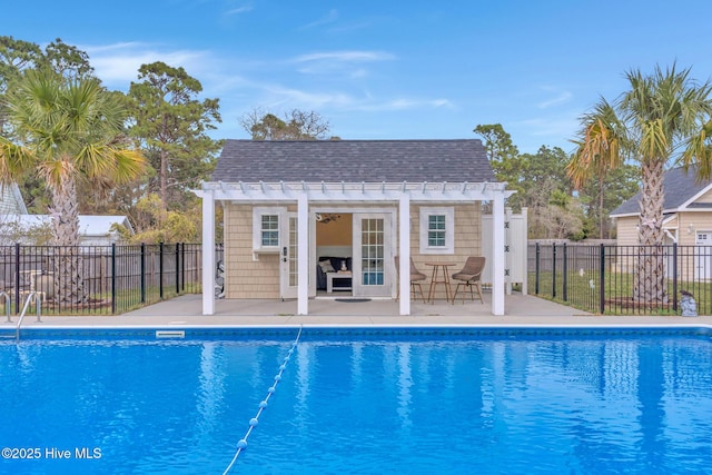 view of pool featuring an exterior structure, a patio, an outdoor structure, and fence