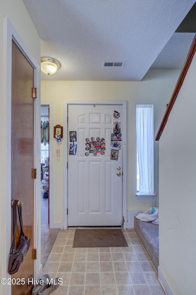 entrance foyer with a textured ceiling and visible vents