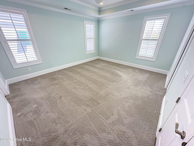 unfurnished bedroom featuring carpet floors, baseboards, visible vents, and ornamental molding