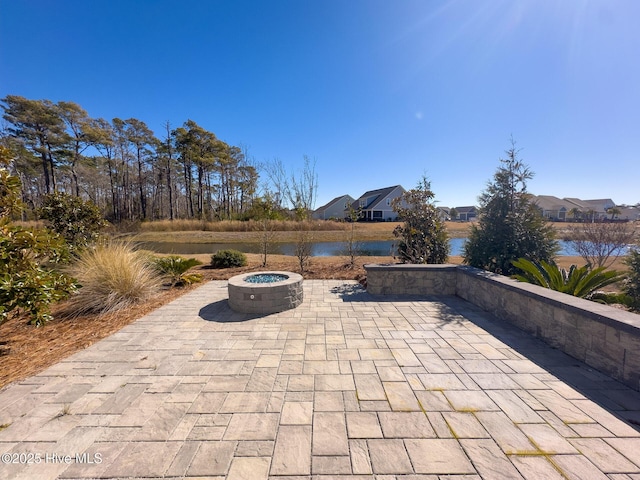 view of patio / terrace with a water view and an outdoor fire pit