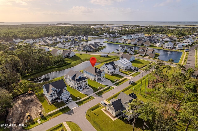 birds eye view of property featuring a water view and a residential view