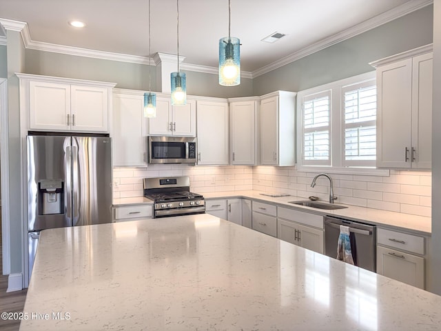 kitchen with stainless steel appliances, a sink, visible vents, and crown molding