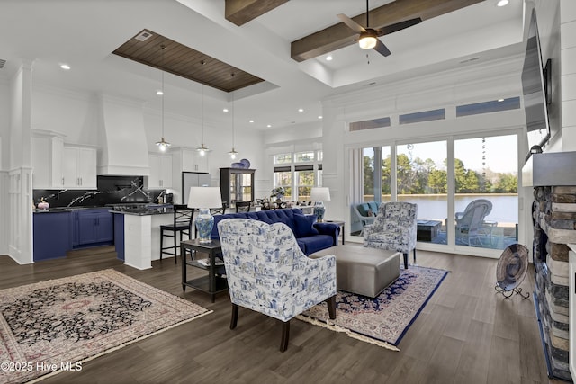 living area featuring a towering ceiling, a ceiling fan, and recessed lighting