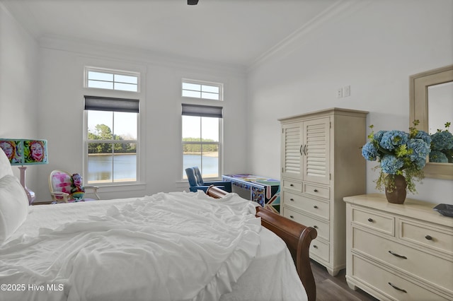 bedroom with ornamental molding, dark wood-style flooring, and a water view